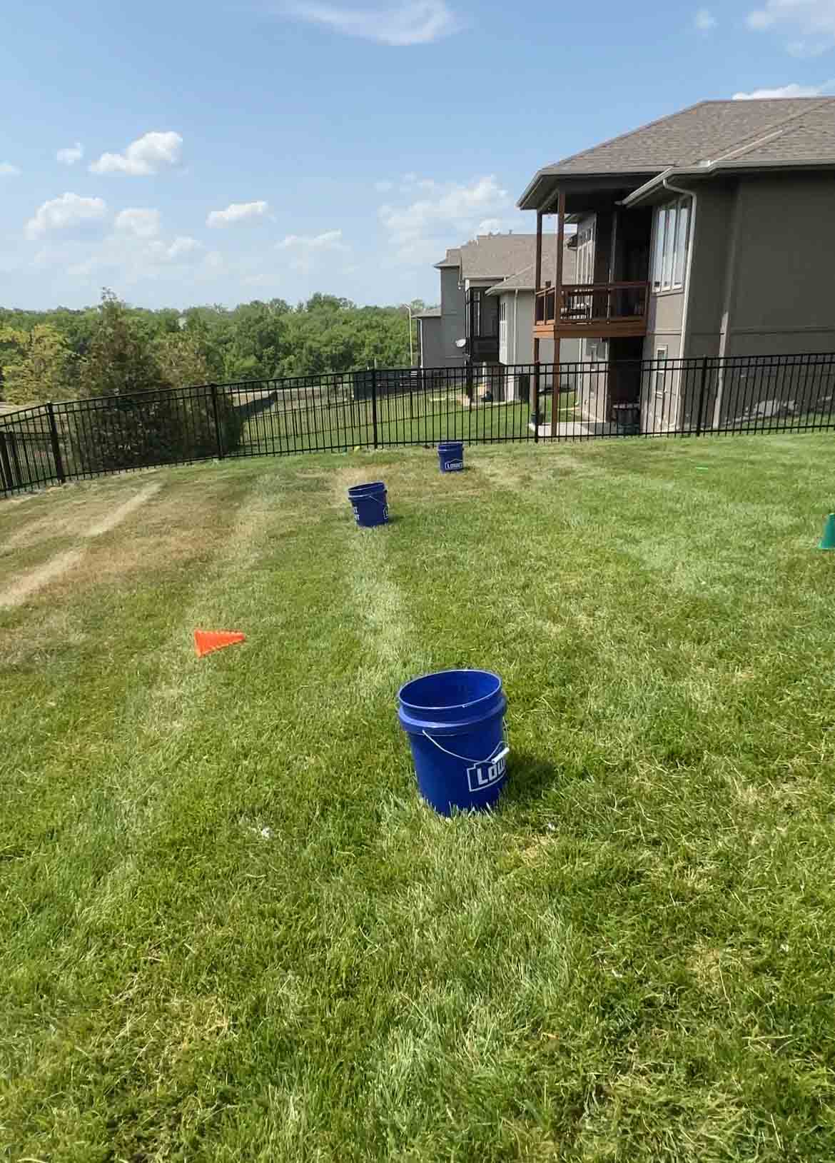 three buckets in a backyard