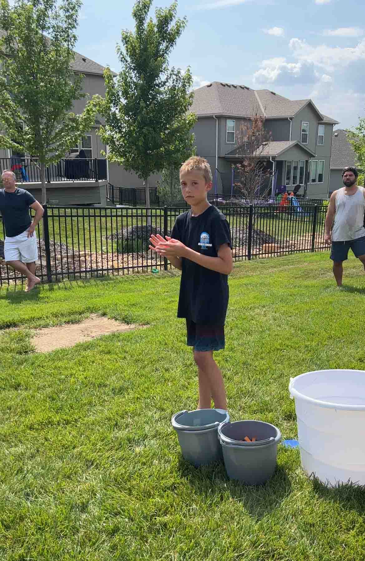 pitcher standing with a bucket of water balloons and sponges