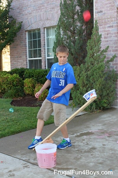 kid shooting a water balloon launcher