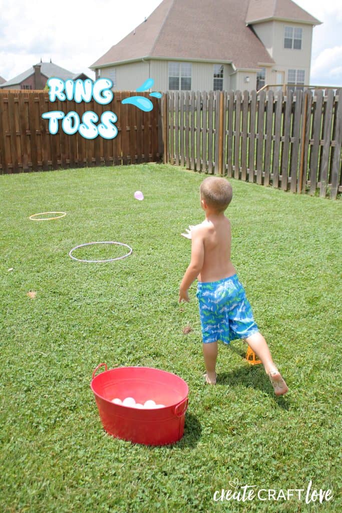 kid playing water balloon games in the yard