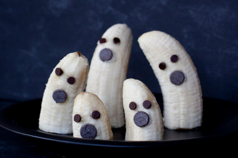 peeled and cut bananas with chocolate chip faces
