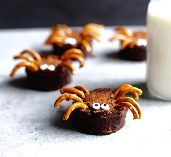 brownie bites topped with pretzel spider legs