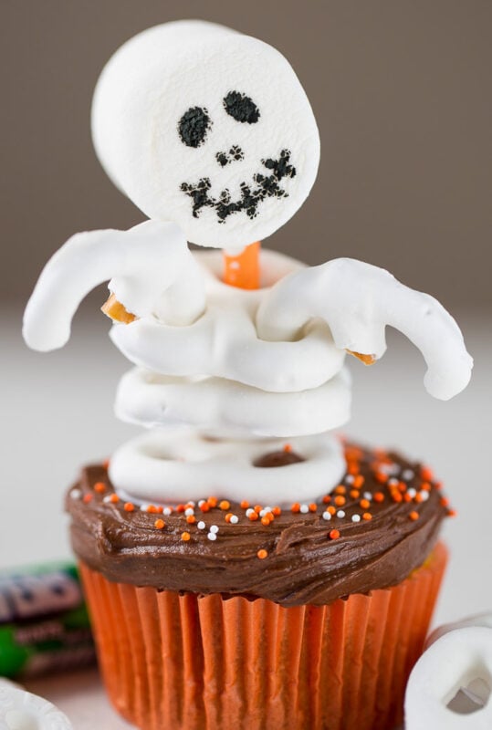 cupcake topped with pretzel skeleton