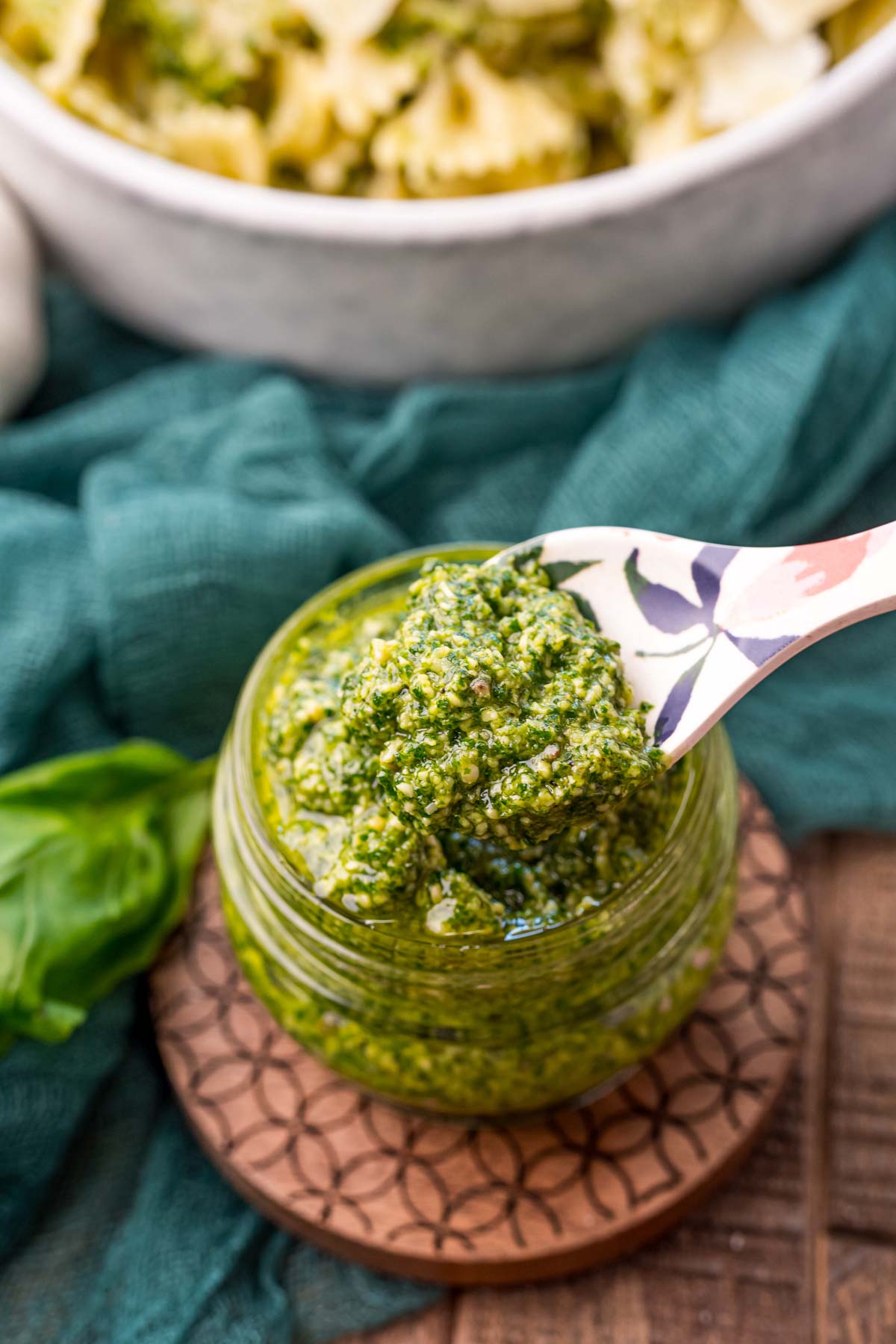 spoon lifting a spoon full of creamy pesto sauce