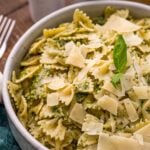 bowl of creamy pesto pasta with parmesan on top