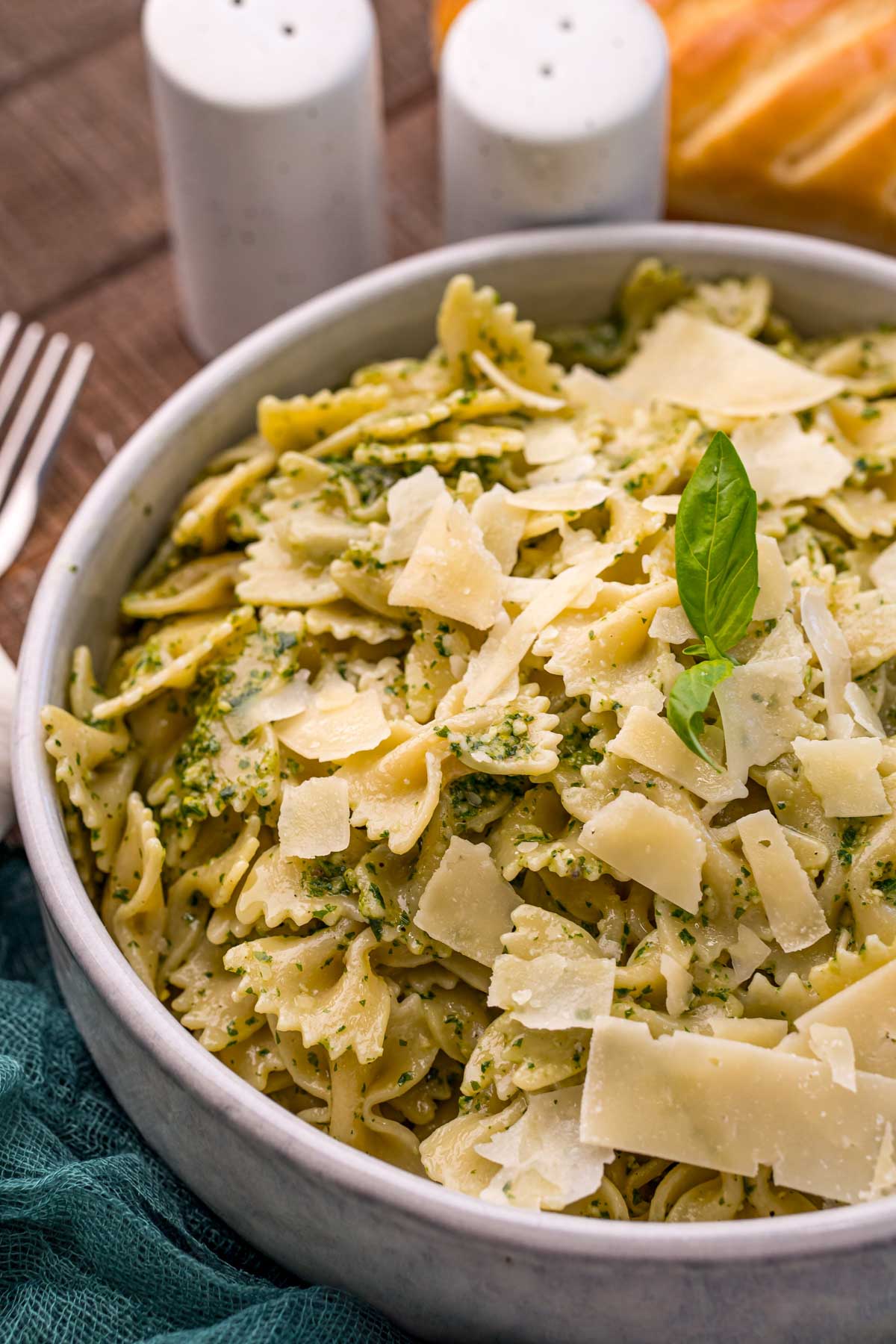 bowl of creamy pesto pasta with parmesan on top