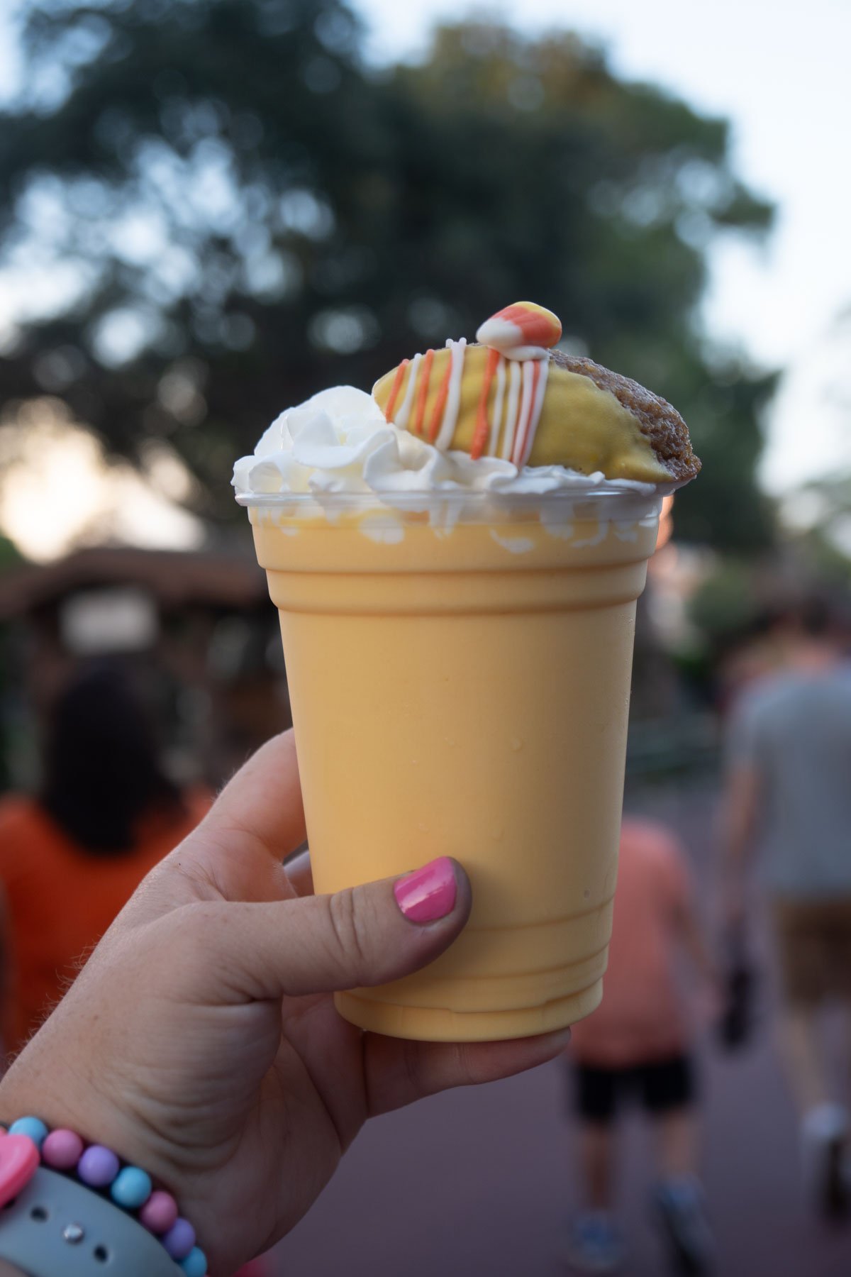 hand holding a candy corn milkshake