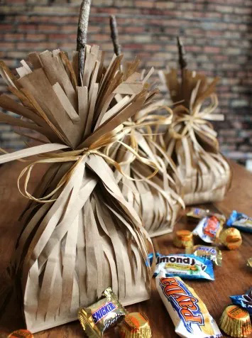 cut brown bag with sticks to look like witches bag
