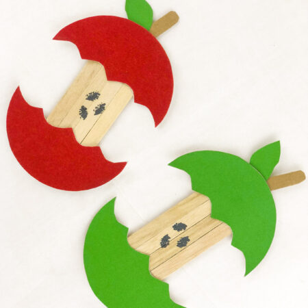 two apple crafts on a white background