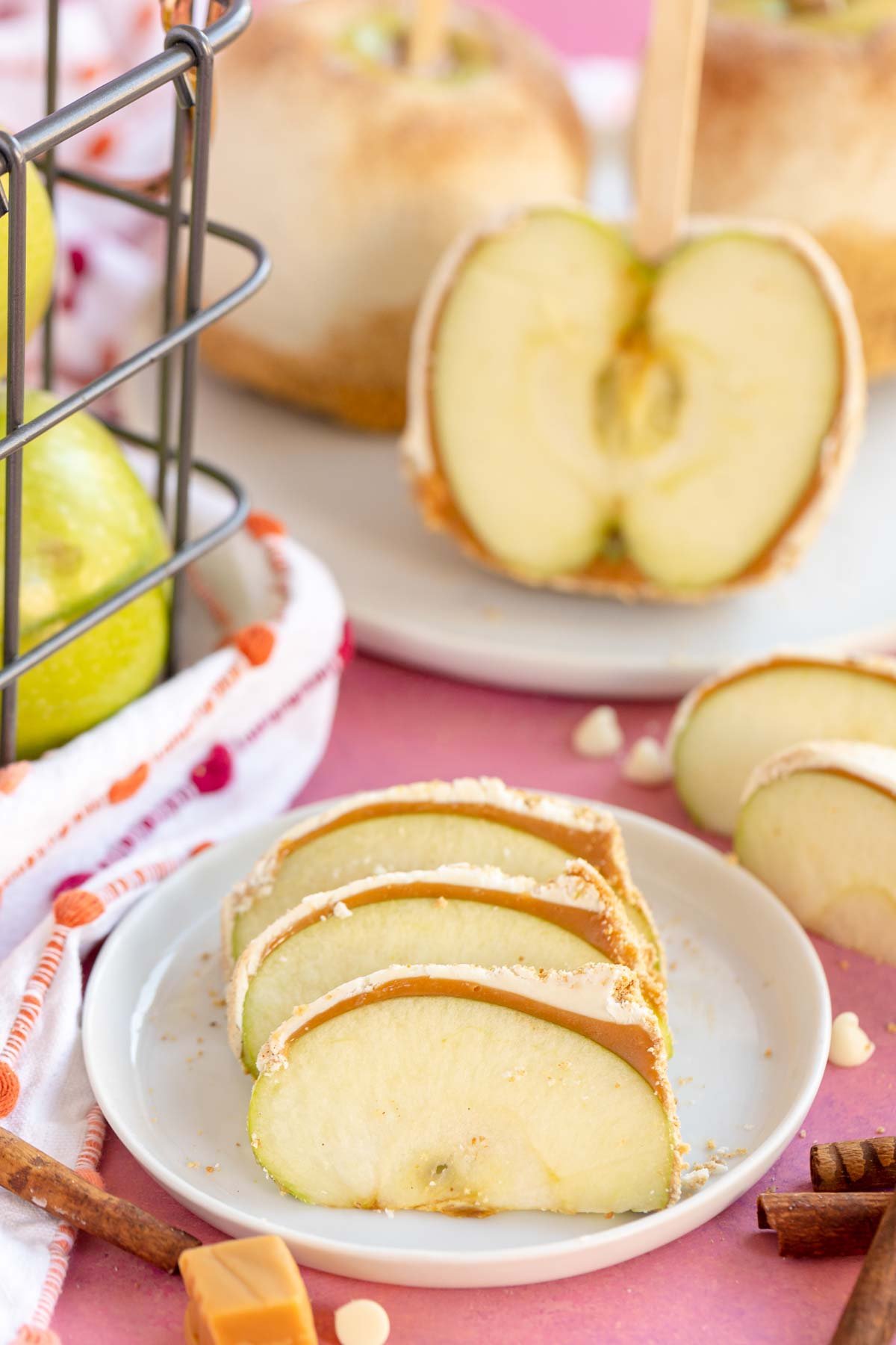 sliced apple pie caramel apples on a white plate