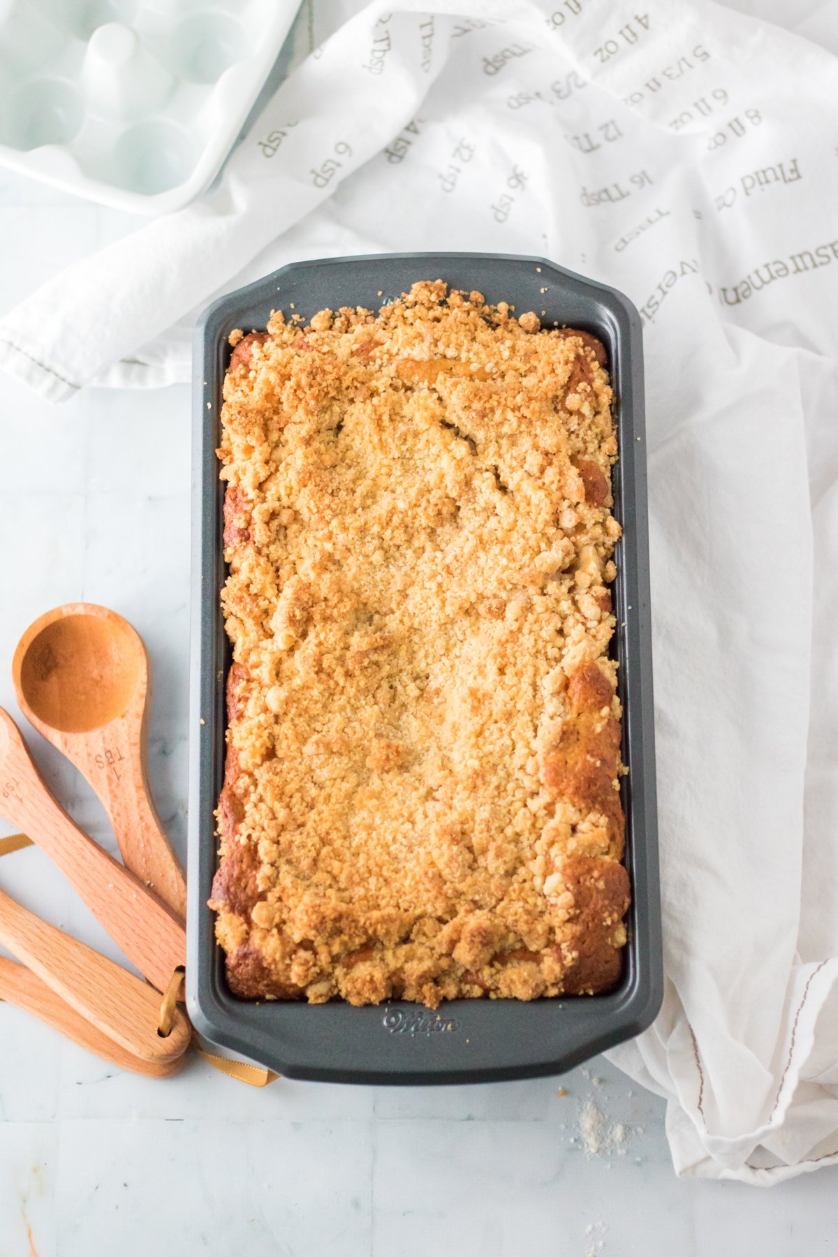 baked apple streusel cake in a baking pan