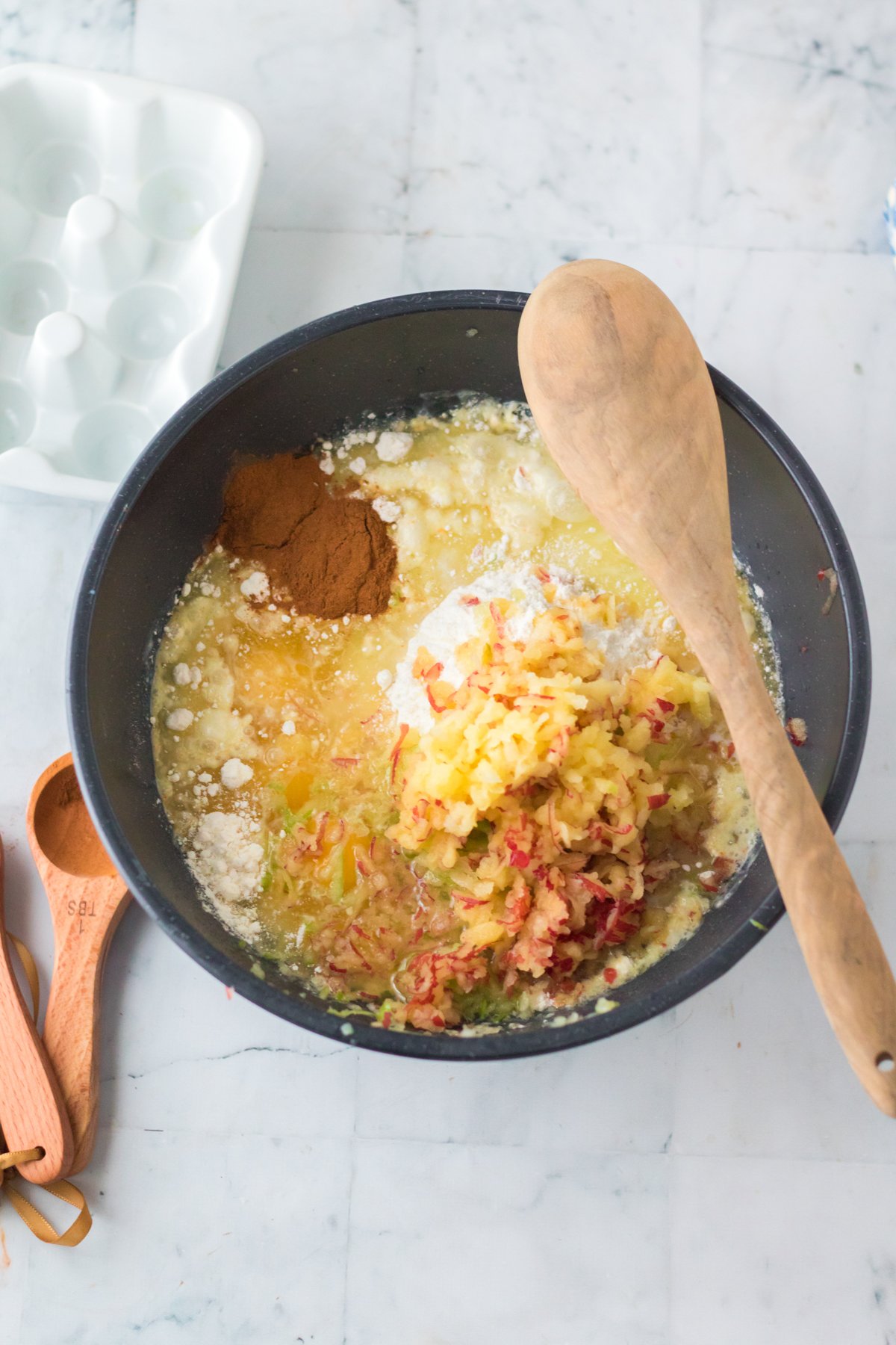 mixing bowl with ingredients to make apple streusel cake 