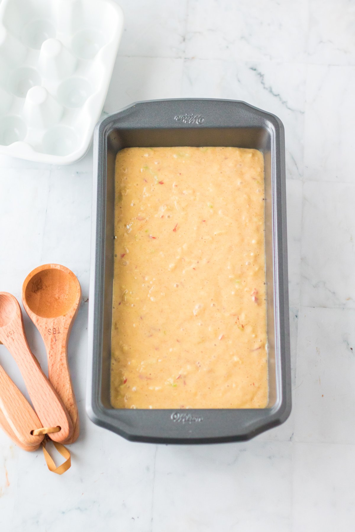 apple streusel cake batter in a baking pan