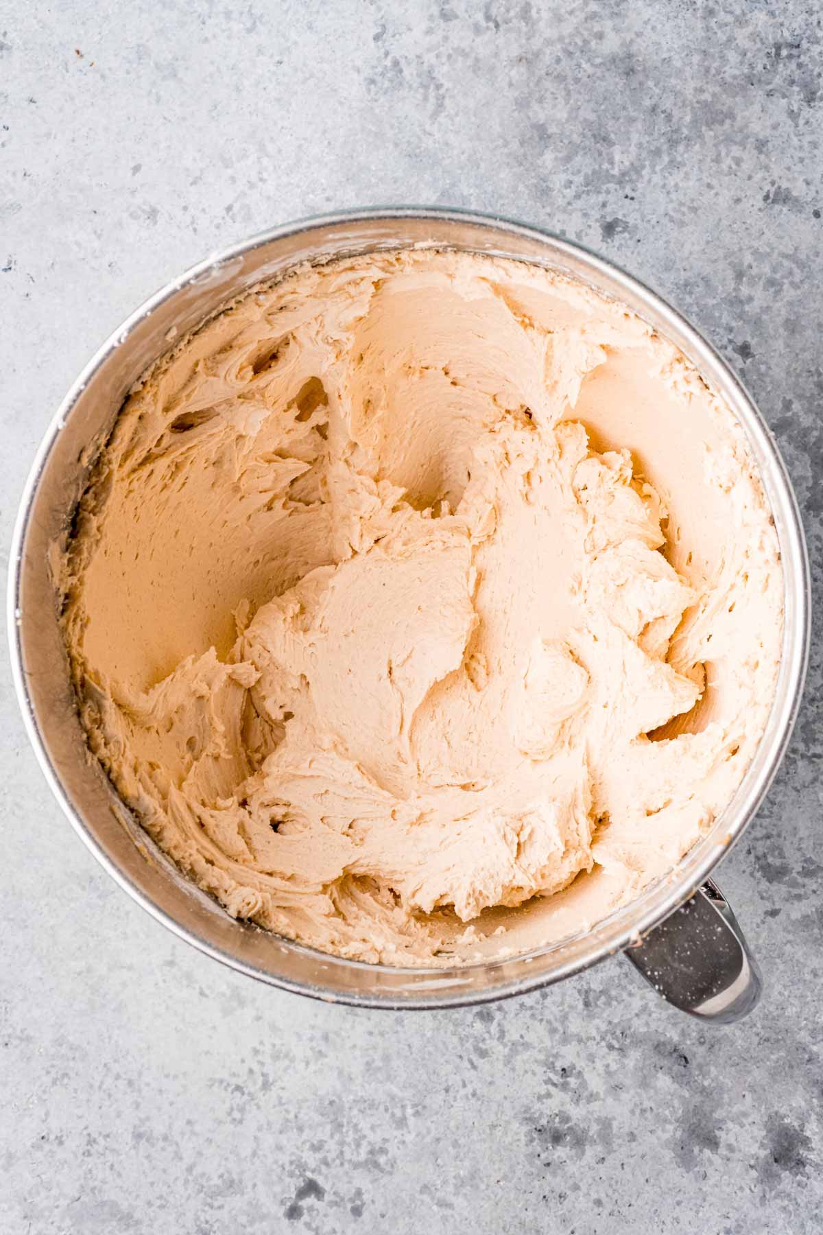 peanut butter frosting in a metal mixing bowl