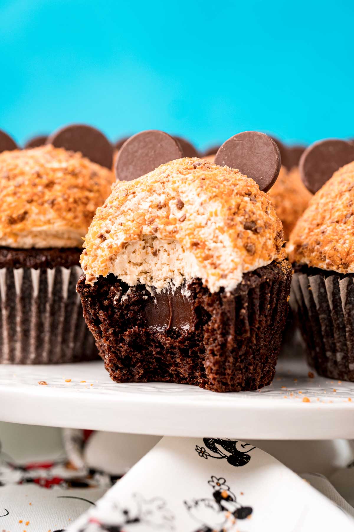 butterfinger cupcakes on a cake stand with a bite out of them