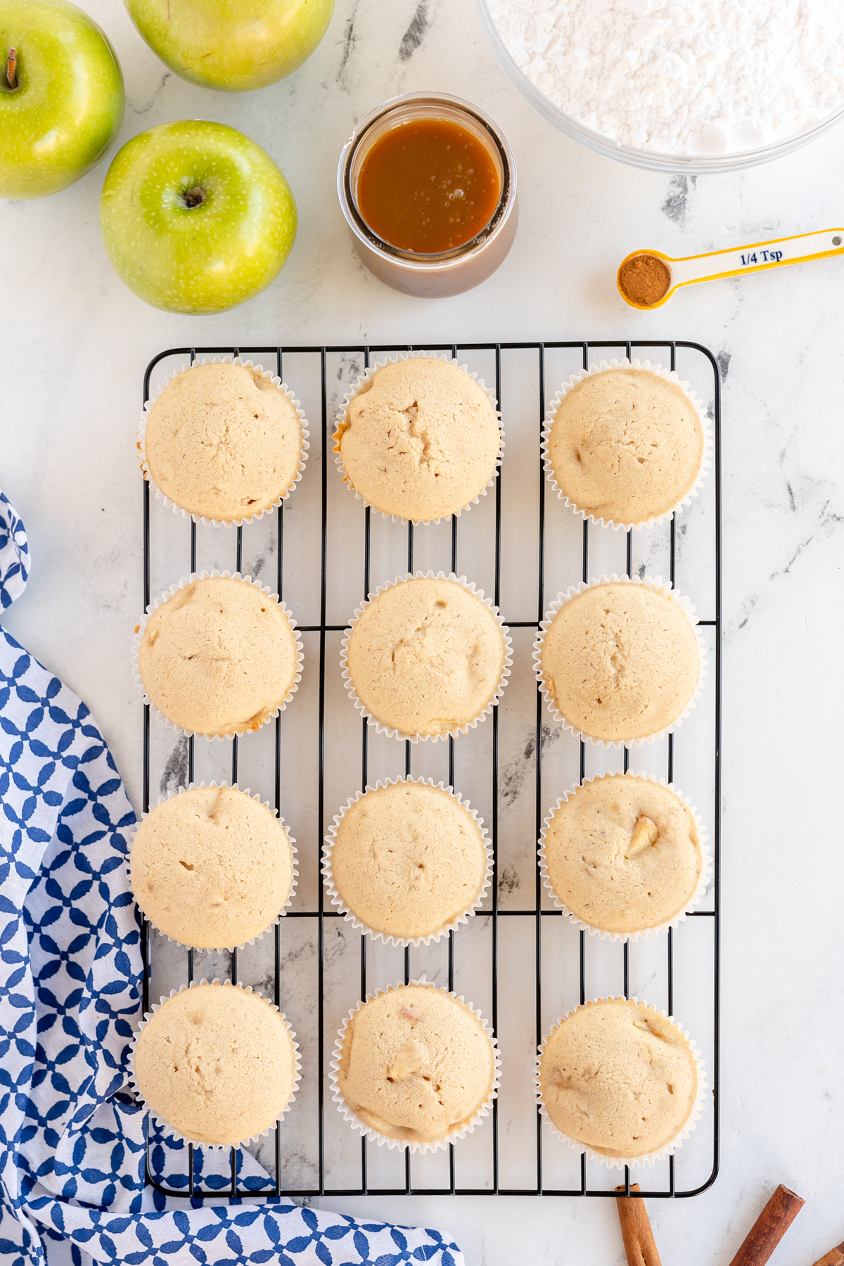 cooling rack with baked caramel apple cupcakes