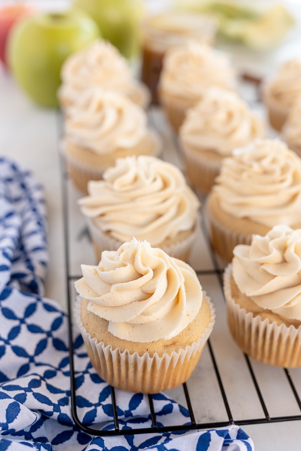 frosted caramel apple cupcakes on a cooling rack