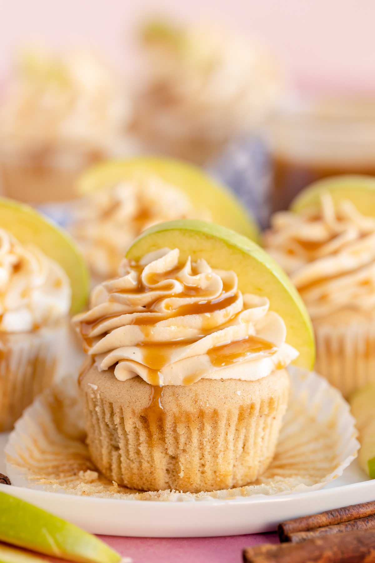 caramel apple cupcake with caramel drizzle and an apple slice
