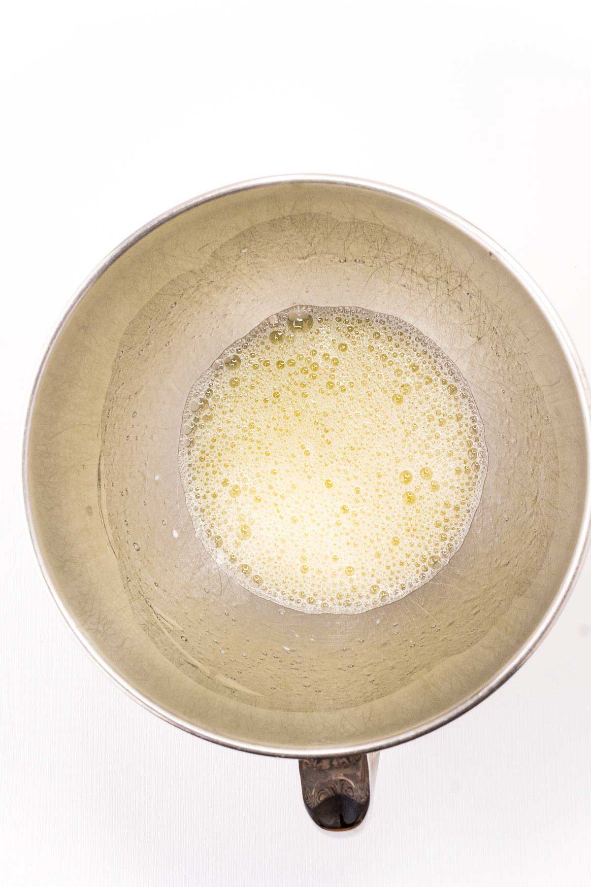 foamy egg whites in a mixing bowl