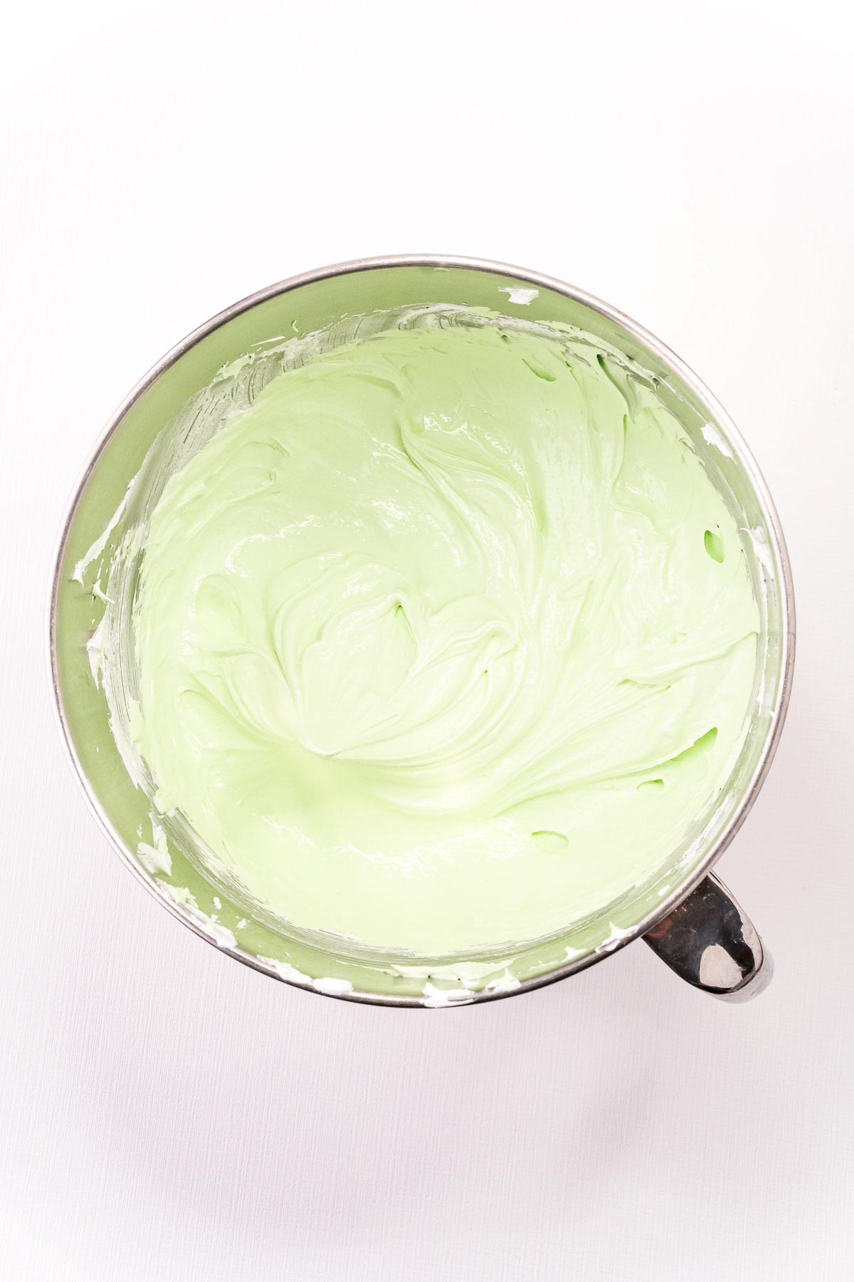 green colored meringue in a mixing bowl
