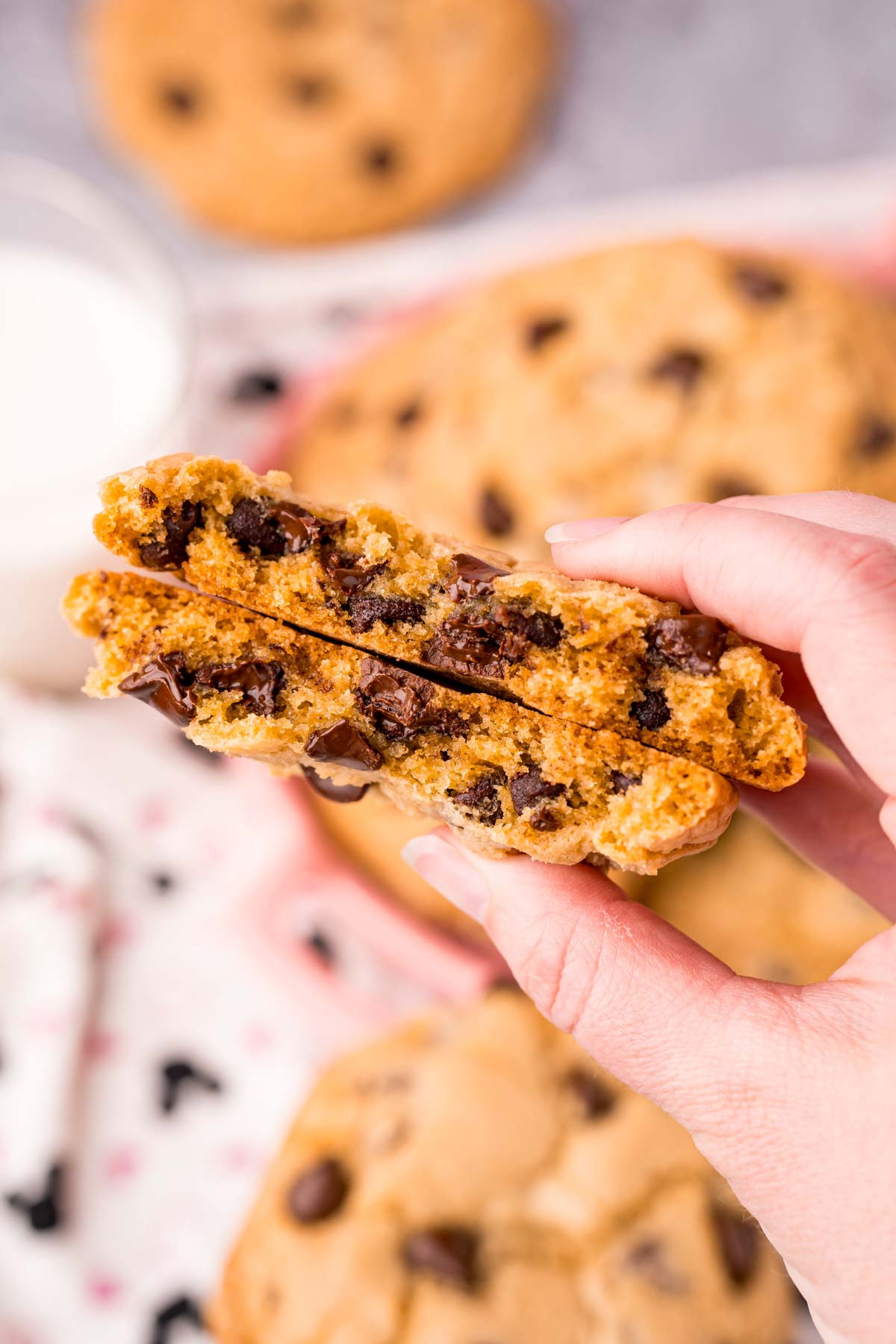 hand holding thick chocolate chip cookies