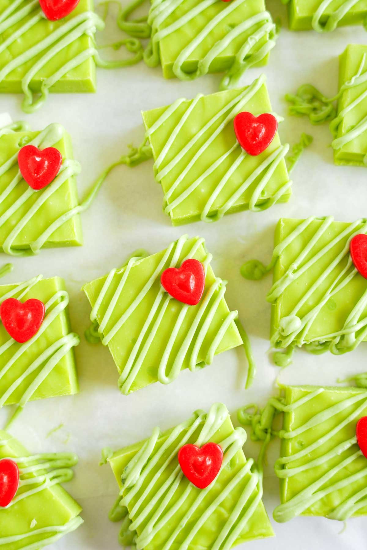 pieces of Grinch fudge on a piece of parchment paper