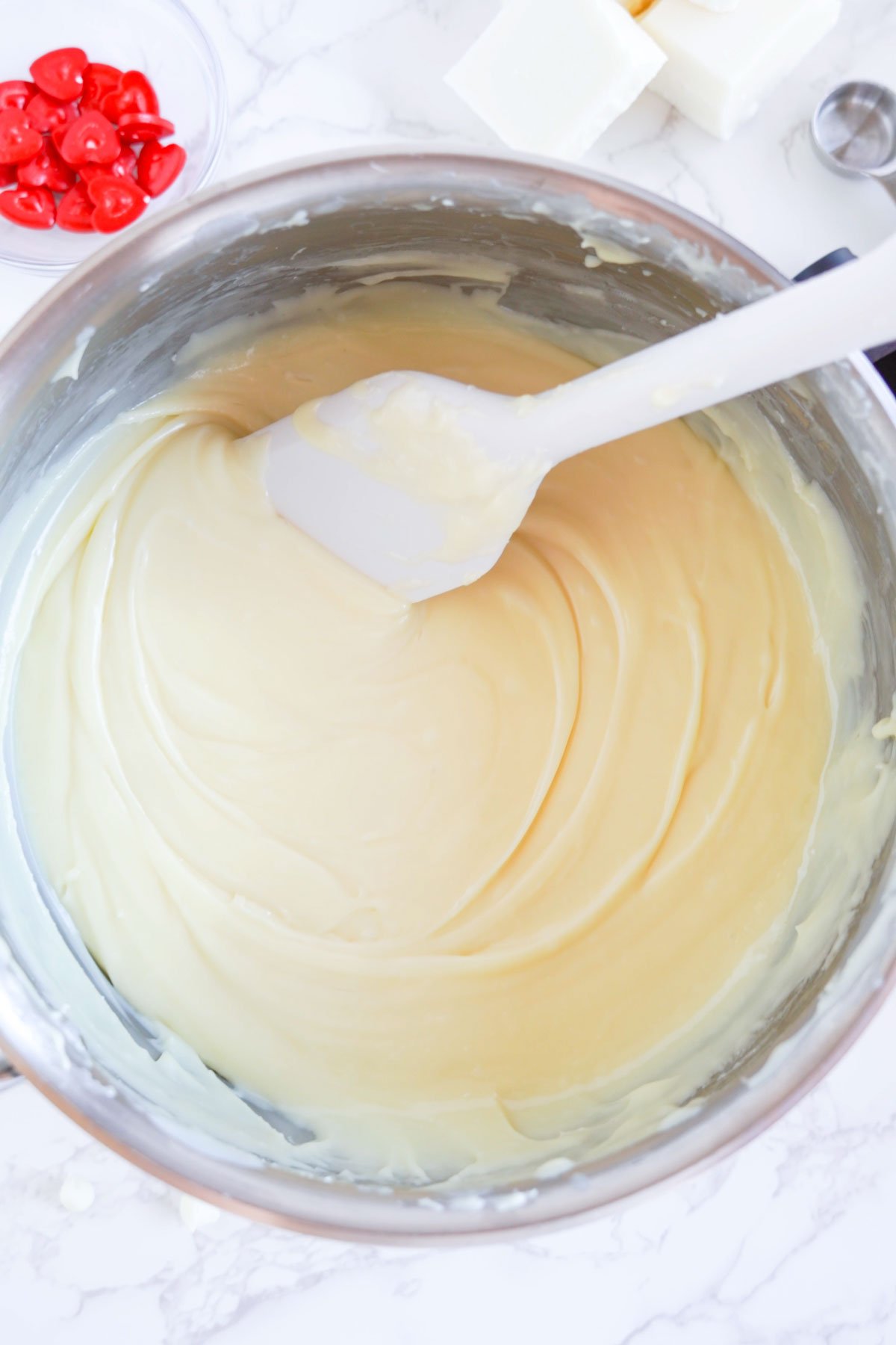 melted white chocolate fudge in a metal bowl