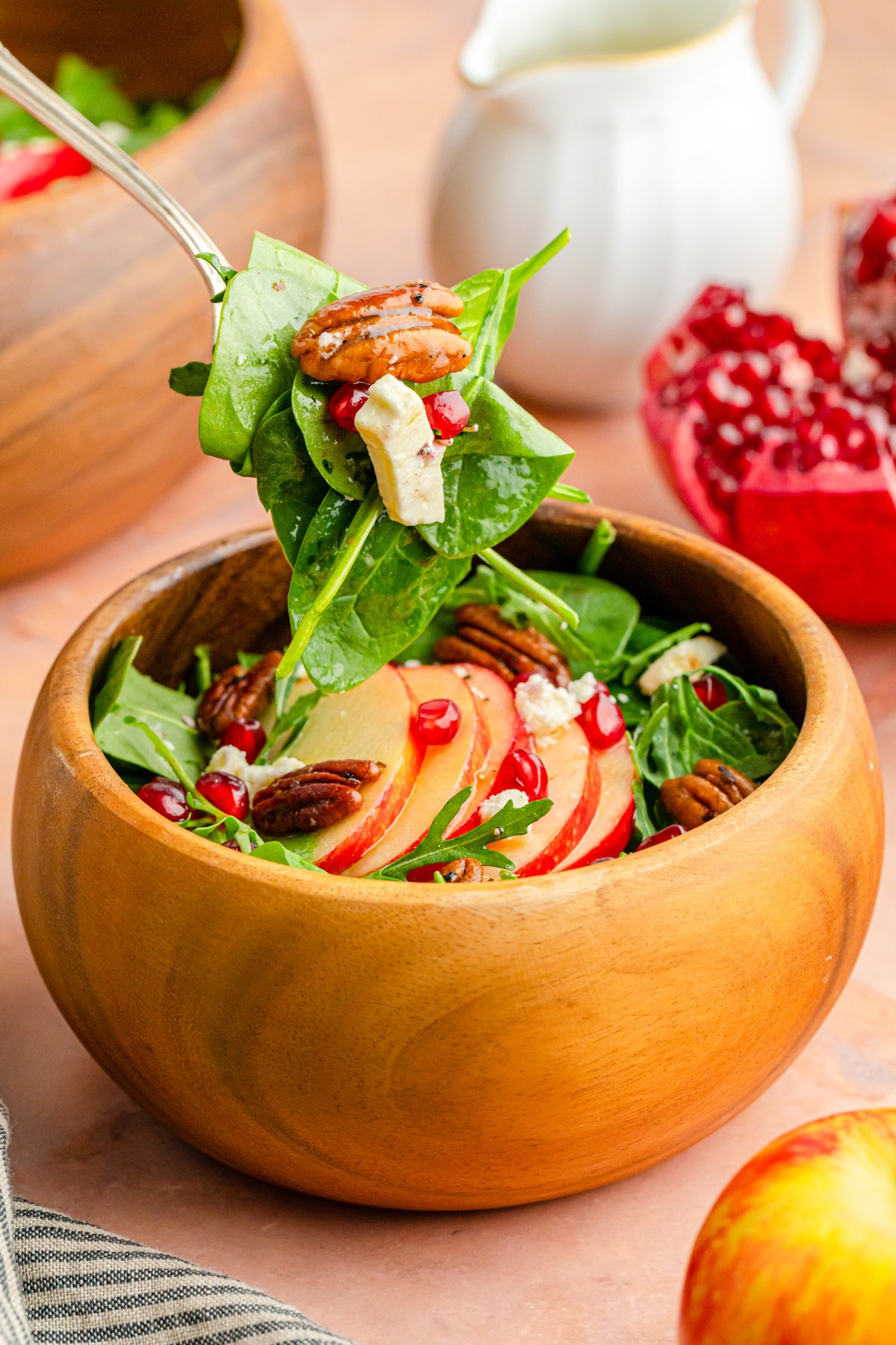 bowl with a fork full of pomegranate feta salad