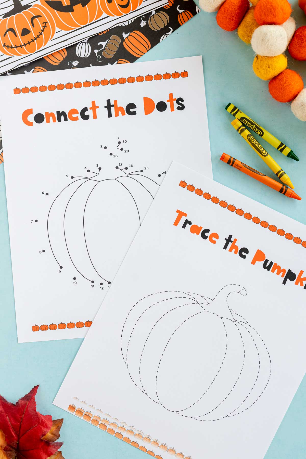 two pumpkin worksheets on a blue background