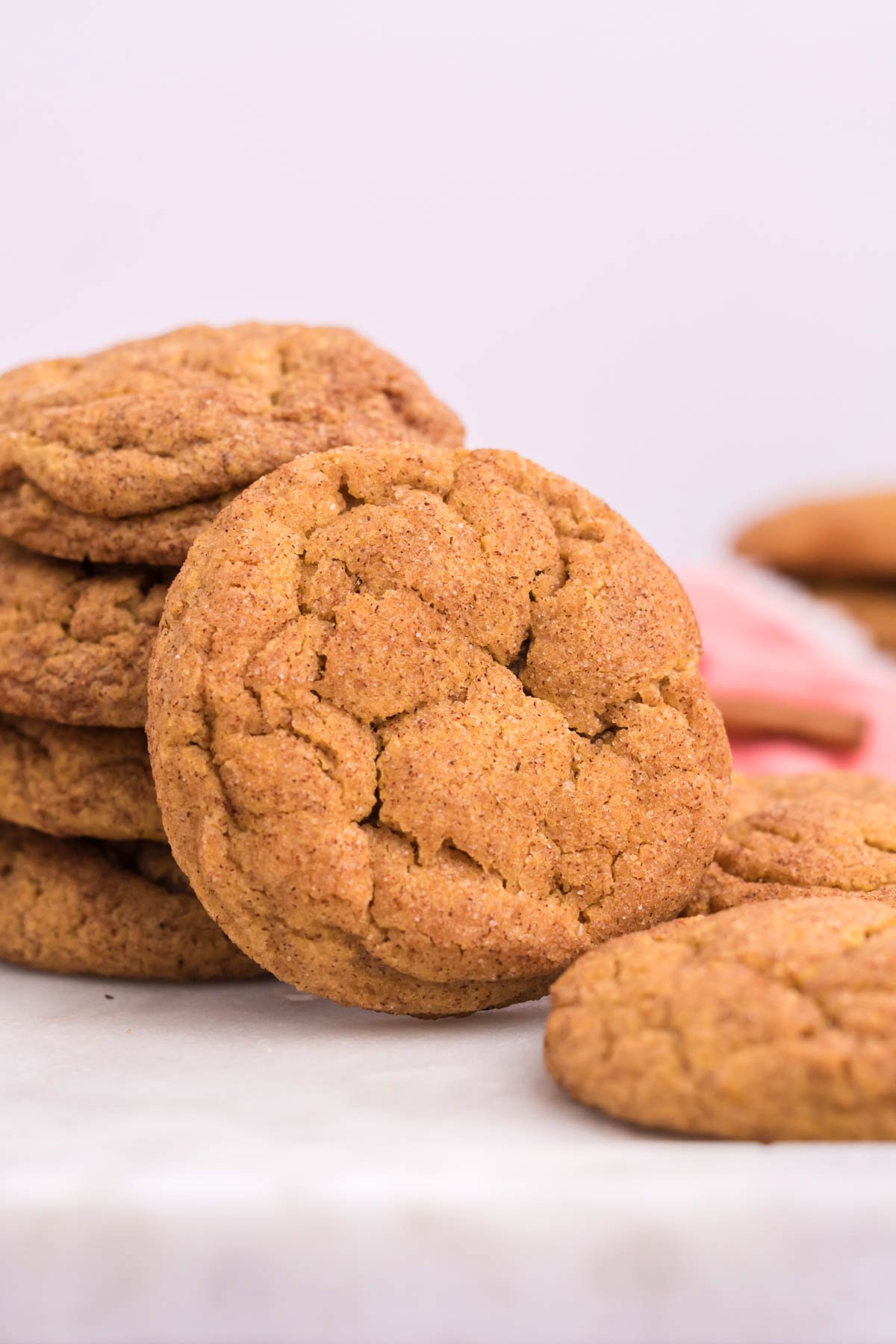 stacks of chewy pumpkin snickerdoodles on a white counter