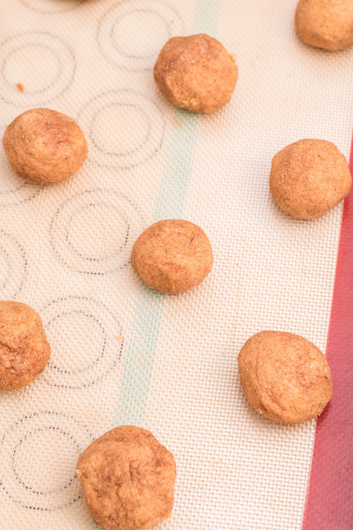 unbaked pumpkin snickerdoodle cookie balls on a baking sheet