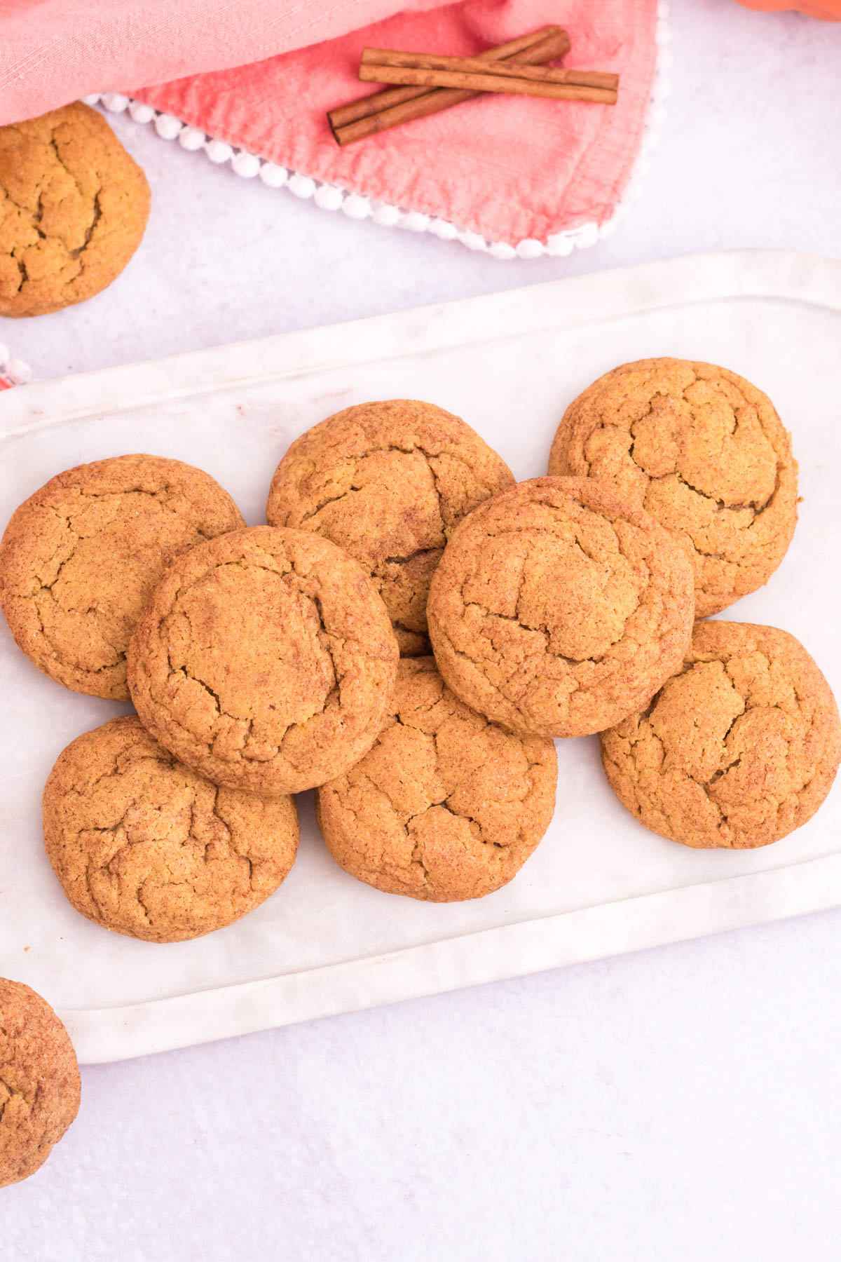 piled up pumpkin snickerdoodles on a white plate