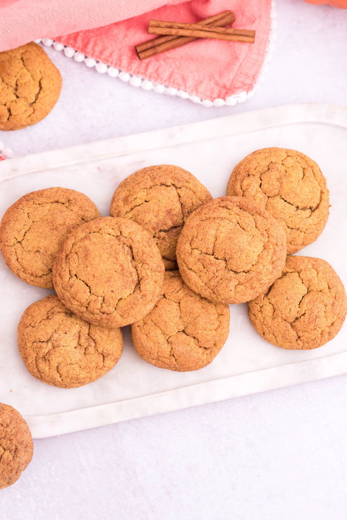 piled up pumpkin snickerdoodles on a white plate