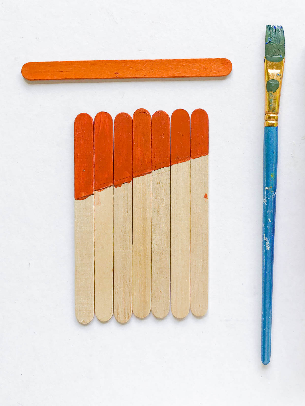 orange painted popsicle sticks