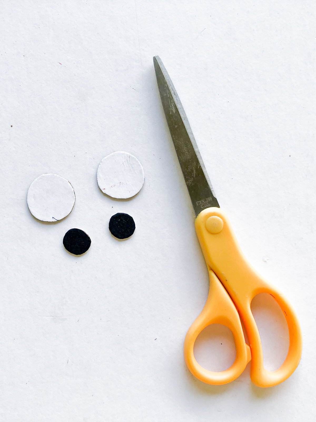 two paper circles with a pair of scissors