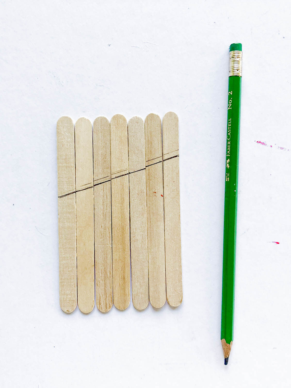 line drawn across popsicle sticks