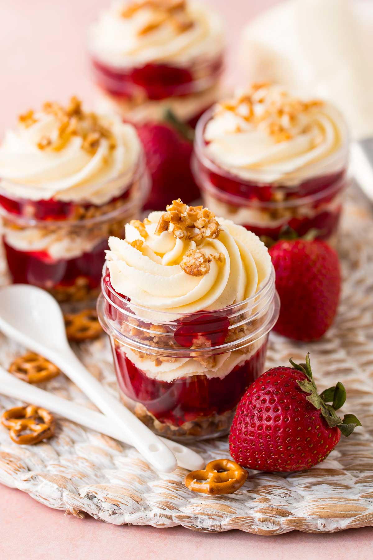 four individual strawberry pretzel salads in jars