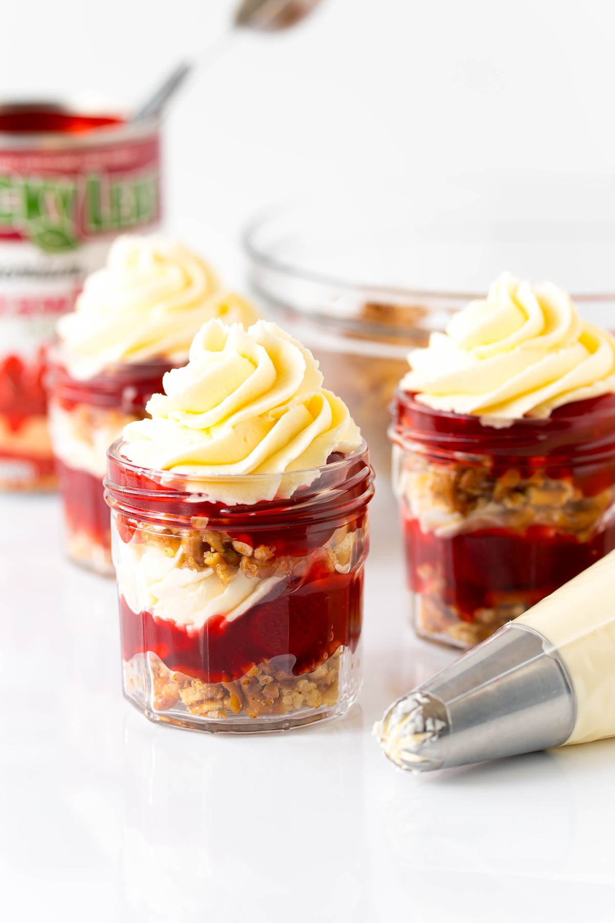 strawberry pretzel salads next to a piping bag full of salad