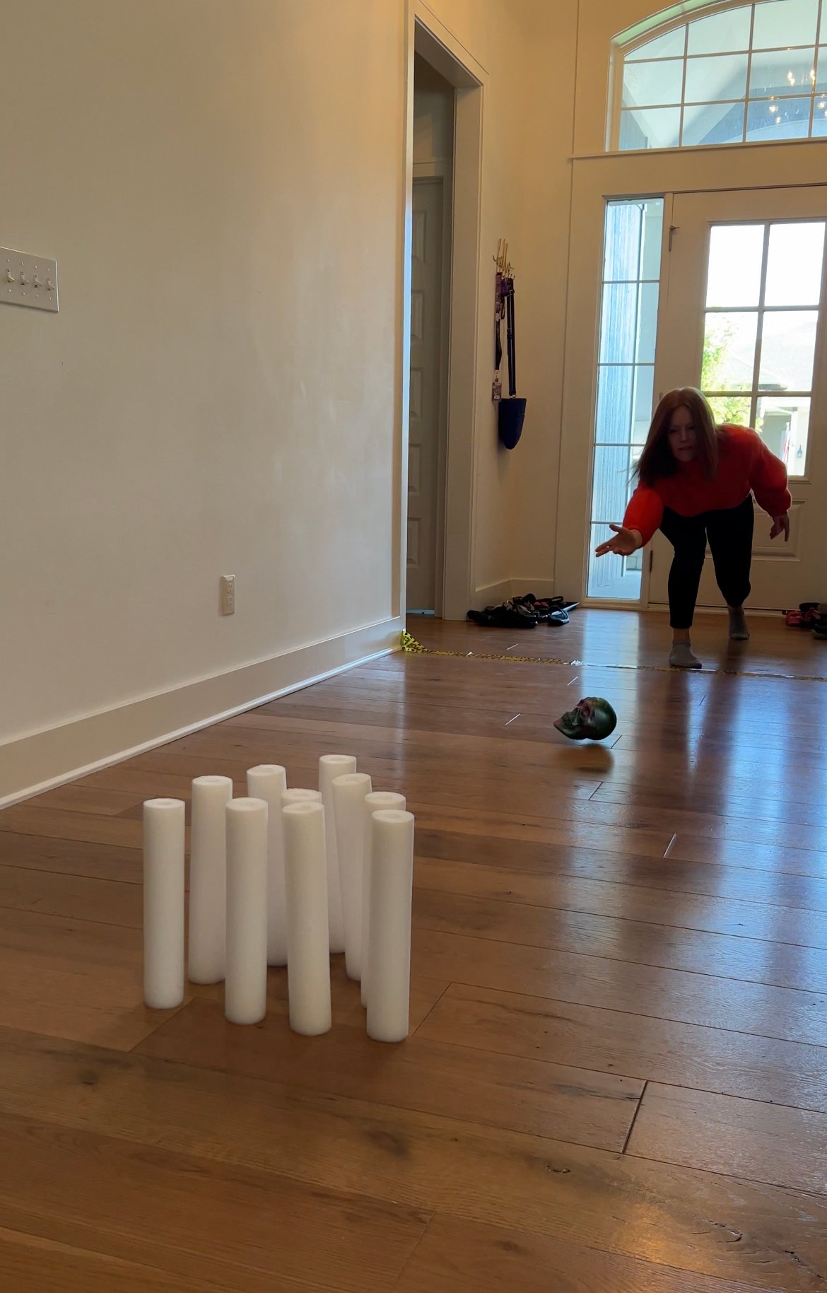 woman playing a ghost bowling game