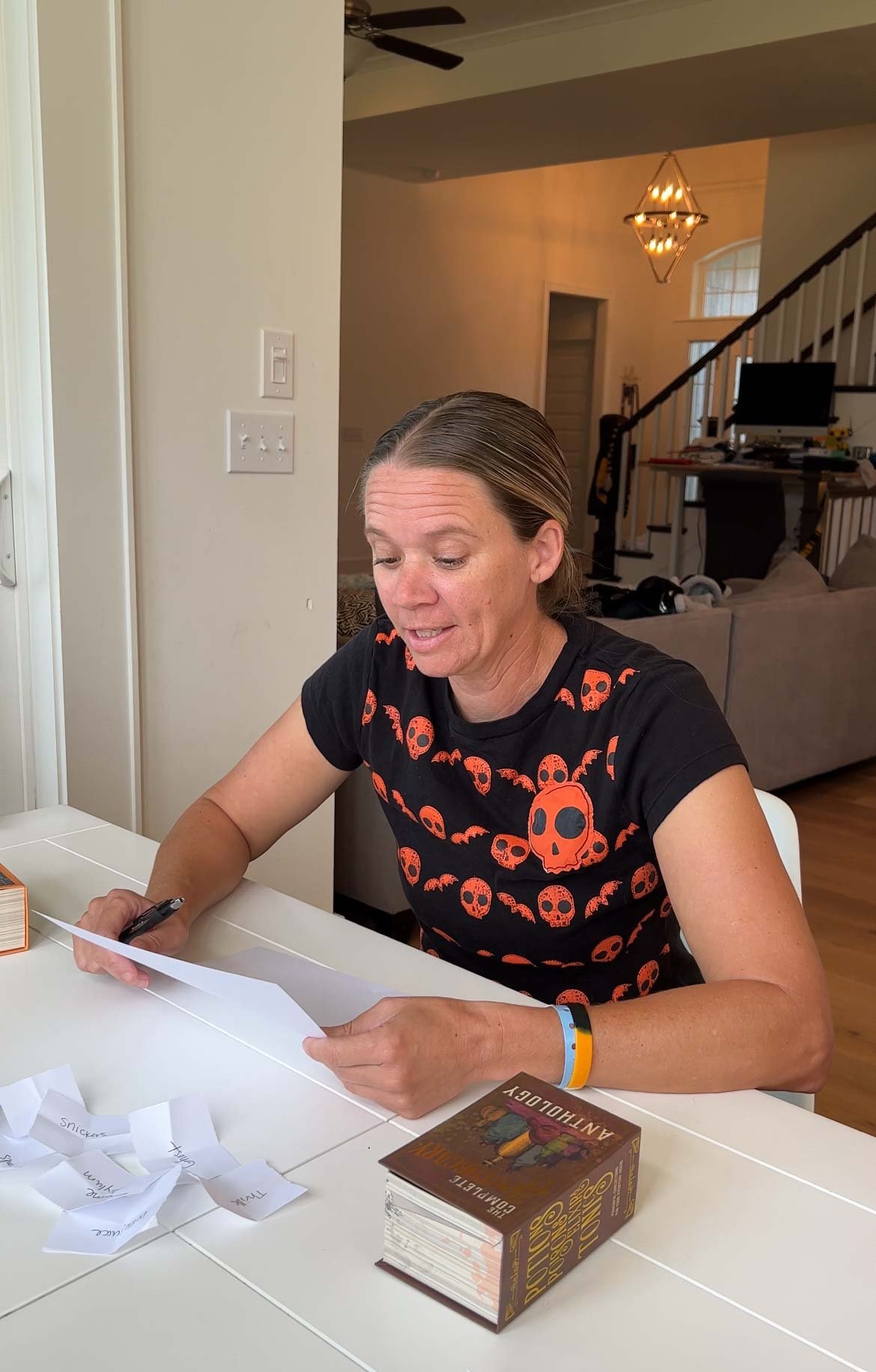 woman reading a story off a white piece of paper