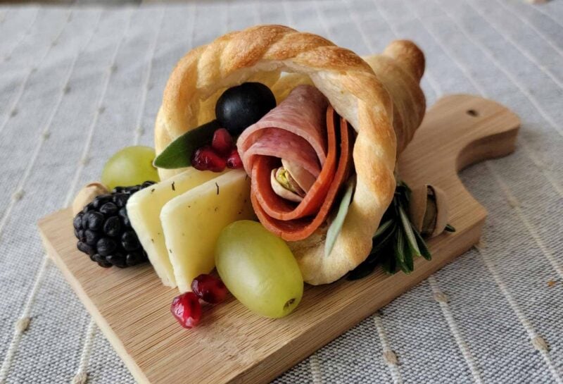 mini bread cornucopia filled with fruit and meats