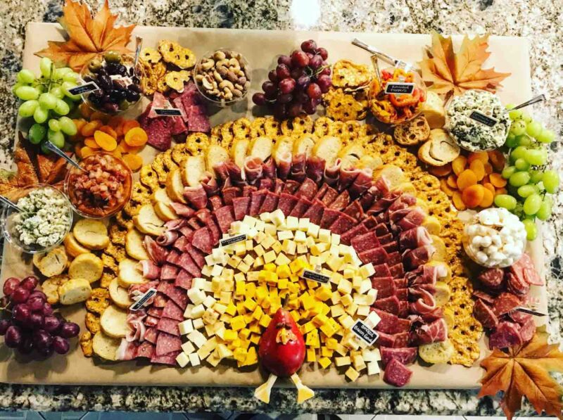 fruit turkey body with layered cheese and meat feathers