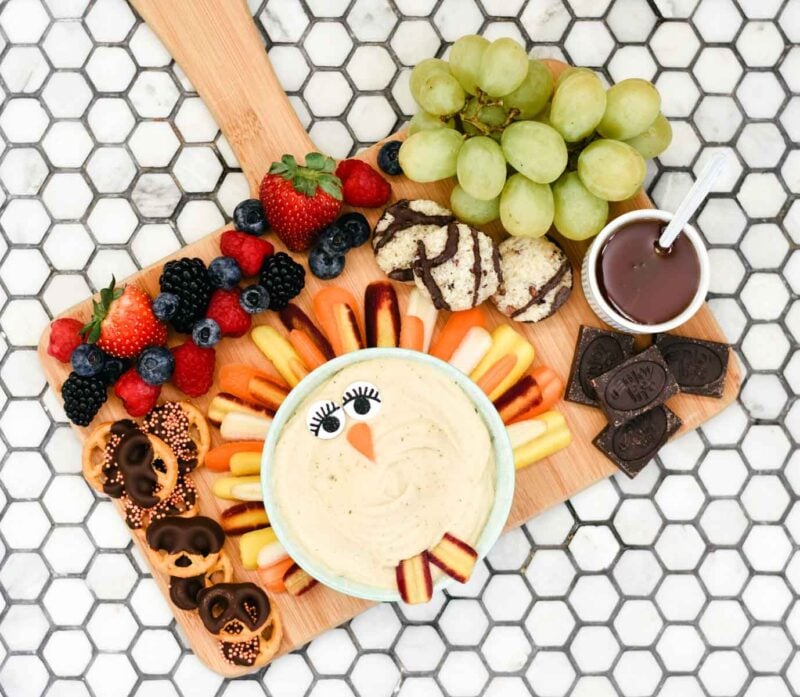 dip with eyes and vegetables to look like a turkey and variety of dippers