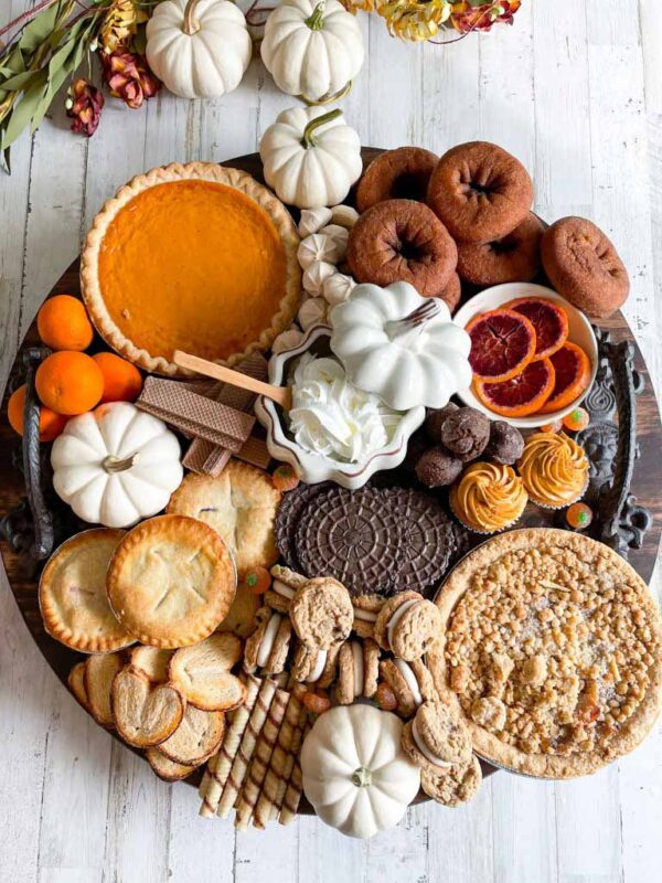 circular board with pie and other sweets
