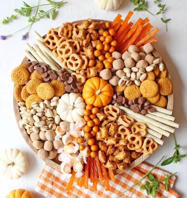 orange and white colored snack with pumpkin decoration on round board