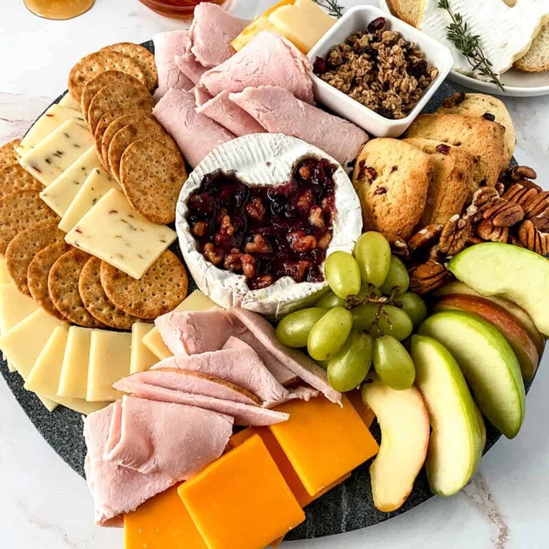 brie cheese with turkey cutout and variety of dipping items around it