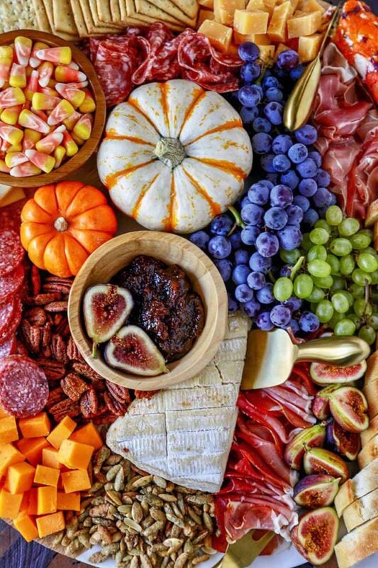 variety of snacking items on round board