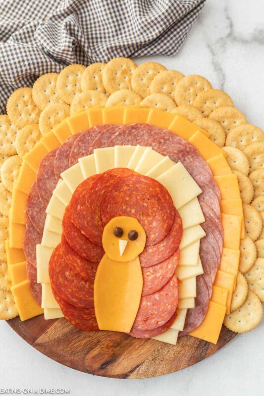 meat and cheese layered as feathers with cheese turkey body