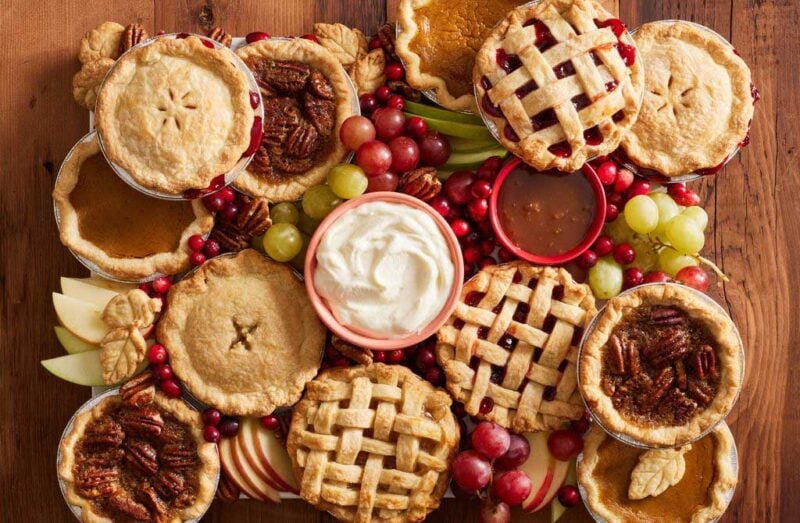 various mini pies with bowl of whipped cream topping