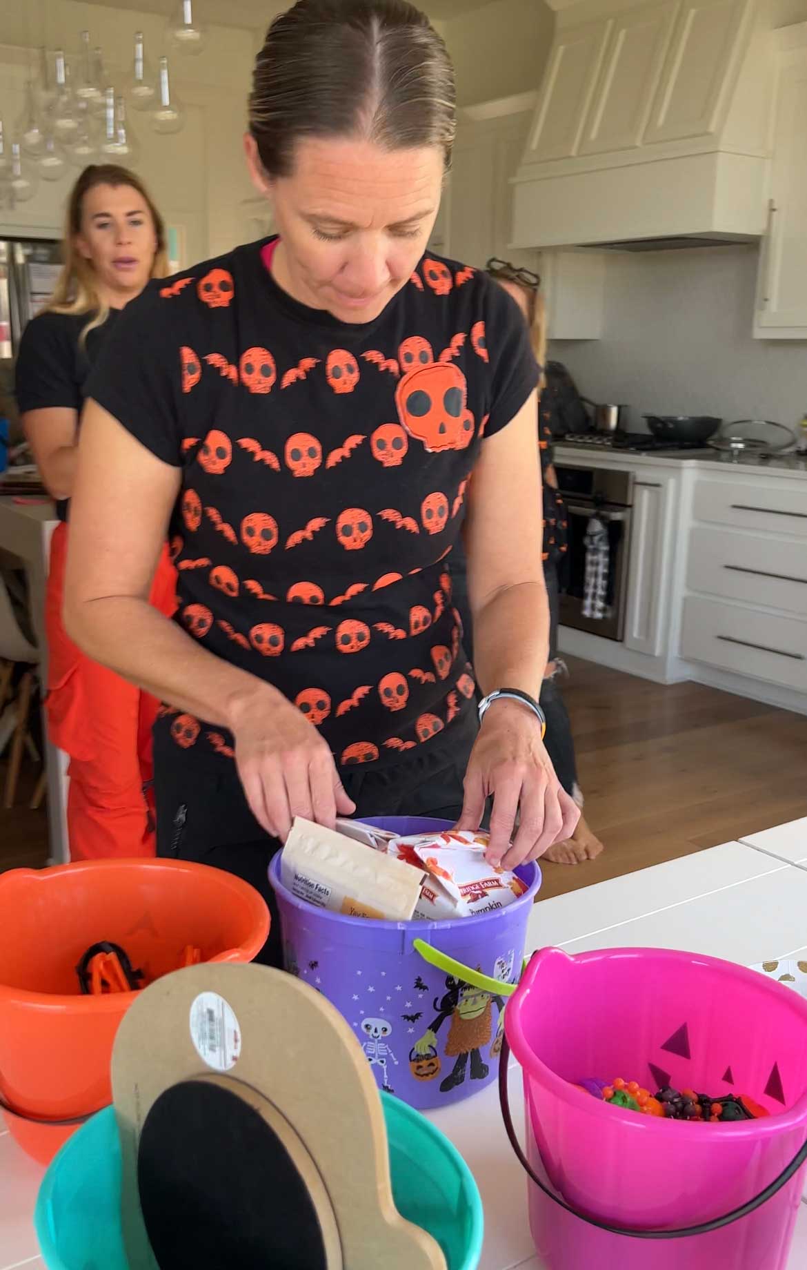 woman picking a prize out of a purple bucket